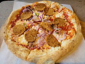 Tomato Base, Vegan Mozzarella, Pizzarami Vegan Sausage, Chilliee and Red Onion at Hangin' Pizzeria in Betws-y-coed