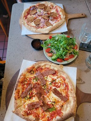Tomato Base, Vegan Mozzarella, Pizzarami Vegan Sausage, Chillies and Red Onion, Sweet Chilli Dip, Side Salad, Tomato Base, and Vegan Mozzarella, Vegan Bacon, Chillies and Maple Syr at Hangin' Pizzeria in Betws-y-coed