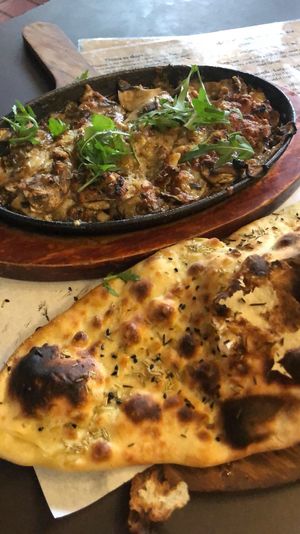 The mushroom bake can be made vegan on request with oil instead of butter and vegan mozzarella instead of dairy cheese.  at Hangin' Pizzeria in Betws-y-coed