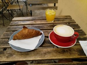 Citrus croissant, orange juice and rice milk cap  at Filter in Pisa