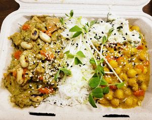 Thai curry (ie. tofu panang) and chana masala w/ cucumber raita, served with rice and paratha. at TVX in Toronto