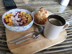 Smoothie bowl and almond croissant  at Bayon Pastry School Coffee Shop in Siem Reap