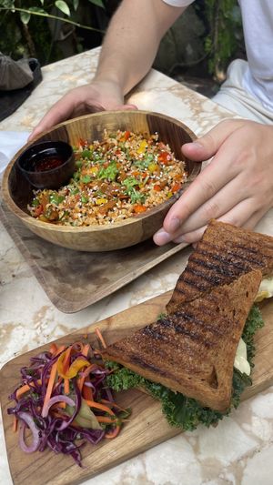 Stir fry chicken rice & pesto cheese toastie !!   at Loving Earth Cafe in Fort Kochi