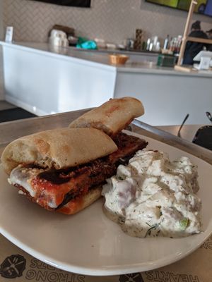 Eggplant Parm with dill potato salad side at Strong Hearts in Syracuse