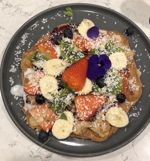 Vegan waffle with coconut cream and cashew butter  at POG - Tara St in Dublin