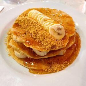 Vegan pancakes with crushed digestive, banana and maple syrup at POG - Tara St in Dublin
