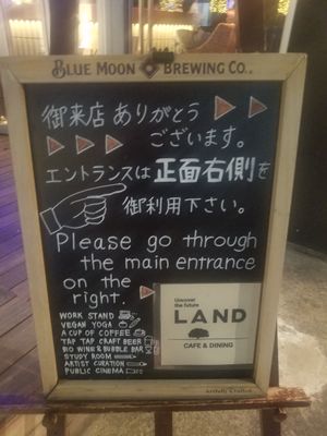 Signboard says "vegan yoga" at Land Cafe in Tokyo
