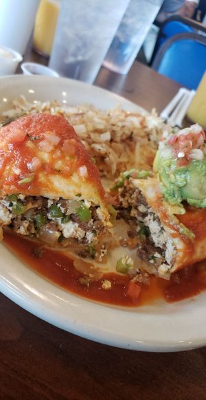 Chorizo burrito with hashbrowns - Scrambled tofu, plant-based chorizo, potatoes, green bell peppers, onions, and plant-based cheese. Topped with ranchero sauce, avocado and pico de at Sunnyside Diner - NW 6th St in Oklahoma City