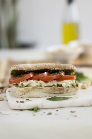 Panino Caprese - Handmade Ciabatta Bread made locally in @tahonapanartesanal spread with our Pesto and Cashew & Almonds Mozzarella, vegan & organic. Fresh Basil & Tomatoes. at Gardeno in Tijuana