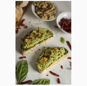 Handmade Loaf Slices made locally spread with our Vegan Pesto and Guacamole, topped off with chiles secos. at Gardeno in Tijuana