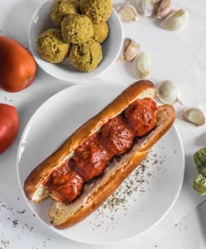 Meatball Sub - Zuchinni & Chickpea meatballs, organic cashew mozzarella covered in marinara sauce. All inside a pretzel bun. at Gardeno in Tijuana