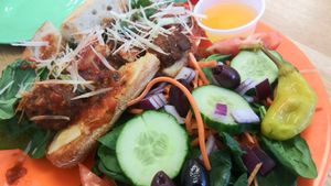 Meatball sub with side salad at Veg Eats Foods  in Delray Beach