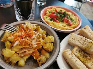 Potatoes with thyme, mustard and lemon (front). Fava beans (back). Bread with oregano (right). at Tarantula in Thessaloniki