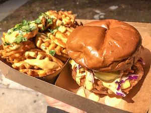 Hot chicken sandwich and waffle fries at Veggie Fam in Los Angeles