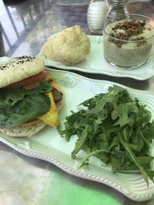 Side biscuit with herbed tempeh gravy and a Sprouted buns sandwich on everything bagel.  at Honey B's in Frankenmuth