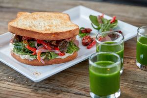 Pure Panino
Our vegan brioche bread toasted with marinated roasted portobello mushrooms, spinach, caramelized peppers and onions, herb roasted cherry tomatoes, creamy smoked aioli  at Delicious Raw Kitchen and Juice Bar - Pine Ridge Rd in Naples