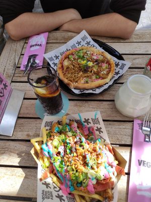 Rainbow fries and TRUF pizza at Vegan Junk Food Bar - Downtown in Amsterdam