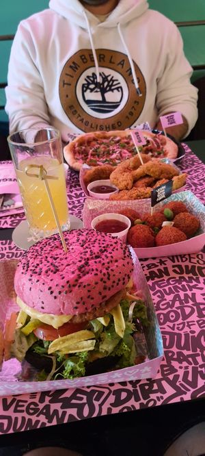 Black and pink bun burger, asian peanut butter balls, vegan wings (so good!) and shawarma pizza. at Vegan Junk Food Bar - Downtown in Amsterdam