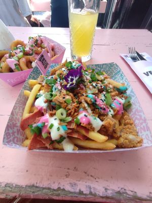 Onion rings and iconic rainbow at Vegan Junk Food Bar - Downtown in Amsterdam