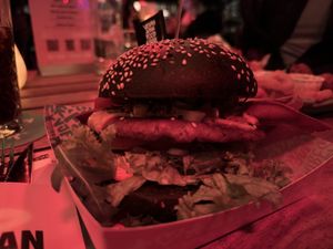  •	Royal Smash. Smashed Beef on Black Bun, cheese, bacon lettuce, tomato, pickle, jalapeño, hot cheese chick sauce     at Vegan Junk Food Bar - Downtown in Amsterdam