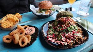 Notorious Sumo Burger & Hulk Burger with Waffle Fries & Onion Rings- super delicious!  at Vegan Junk Food Bar - Downtown in Amsterdam