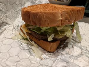 Impossible burger on cosmic toast buns, lettuce, tomato, slaw, asteroid sauce with a vegan swiss cheese slice. at Walt Disney World - Cosmic Ray's Starlight Cafe in Lake Buena Vista