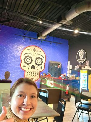 Skull mural with my sister photo bombing lol   at Mariachi's Dine-In in Fort Worth