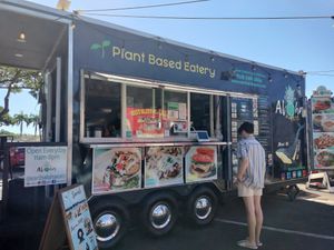 Food trucks are on the highway side of the parking lot at Earth Aloha Eats - Waikiki in Honolulu