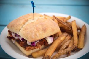 Vegan BBQ Pork Sandwich with rainbow coleslaw. Side of hand-cut fries.  at Earth Aloha Eats - Waikiki in Honolulu