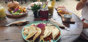 Burger, quesadilla with hibiscus flowers, summer rolls at Arte Sano in Holbox
