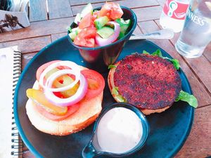 Beet burger with a side salad and tahini.  at Safsal in Tel Aviv