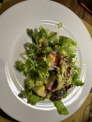 Partially eaten salad with melonn  at Bibliothe in Rome