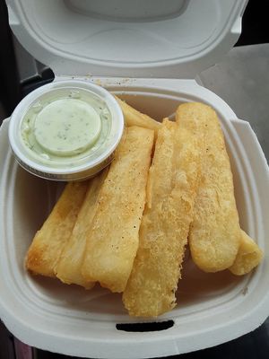 Yuca fries with a delicious house made garlic sauce, order X2 of the sauces! You are going to need it! This is a must have! at The Dragonfly in Ocala