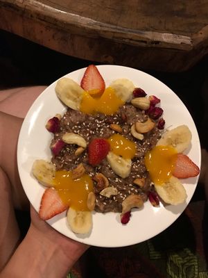 Brown rice pudding with mango purée, fruits and nuts  at Joy in Candolim