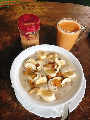Porridge with oats, chia seeds, cashew nuts, banana and raisins 😋😋😋 at Joy in Candolim
