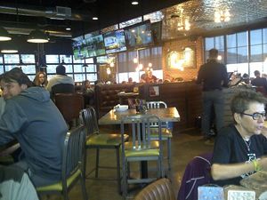 The dining area has a mix of different style chairs and tables. There are also booths. It has a fun & cheerful atmosphere. at Beertown Public House in Burlington