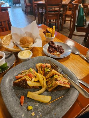 Club sandwich with French fries.  Side of marinated Chipotle peppers. at Yug in Mexico City