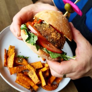 Crumbed mushroom burger served with vegan cheese, rocket, beetroot, onion, capsicum, gherkins served with sweet potato fries at Zein's in Heidelberg