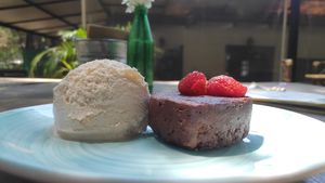 Raw Vegan Brownie with orange (and mezcal?) flavoured icecream. at Cafetería Tambien in Puebla