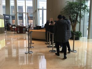 Information counter: show ID and get QR code for elevator access at The Flow in Shanghai