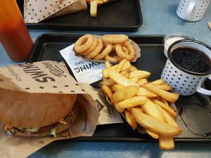 Cheese burger combo with onion rings and cherry cola at Swing Kitchen - Georgenstraße in Berlin