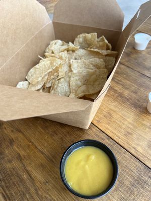 Chips and queso - huge box of chips with a small container of queso.  at Nissi Vegan in Austin