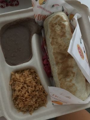 Burrito! Got w cheek’n. Wasn’t expecting the rice n beans lol. Was full on half of the burrito  at Nissi Vegan in Austin