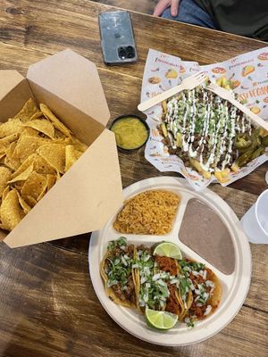 Taco plate (Carne asada and al pastor), Carne Asada fries, Chips and queso   at Nissi Vegan in Austin