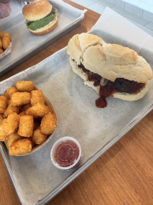 Meatball sub with tater tot’s. It isn’t even cut evenly!   at St. Veg in Rockville