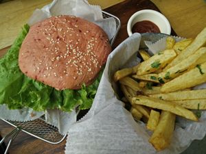Vegan hamburger with beet and lentil patty, and pink beet-infused bun at The Open Kitchen in Monteverde