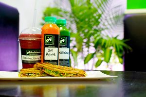 Banana Berry Blast, 24 Karat and Kalicious shown with Basil Pesto Panini at Alkalicious Cold Pressed Juice Bar in Chesapeake