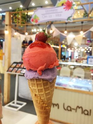Strawberry and sweet purple potato ice cream along with waffle cone special for vegetarians. at Om La Mai in Chiang Rai