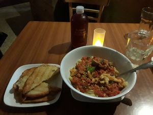Macaroni with vegan sausage and tomato sauce with a side of garlic bread. at Leafy Greens Cafe in St Petersburg