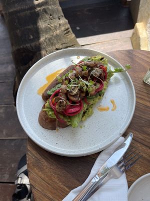 Vegan avocado toast with mushrooms and a vegan sausage  at Salty Swami's in Hikkaduwa